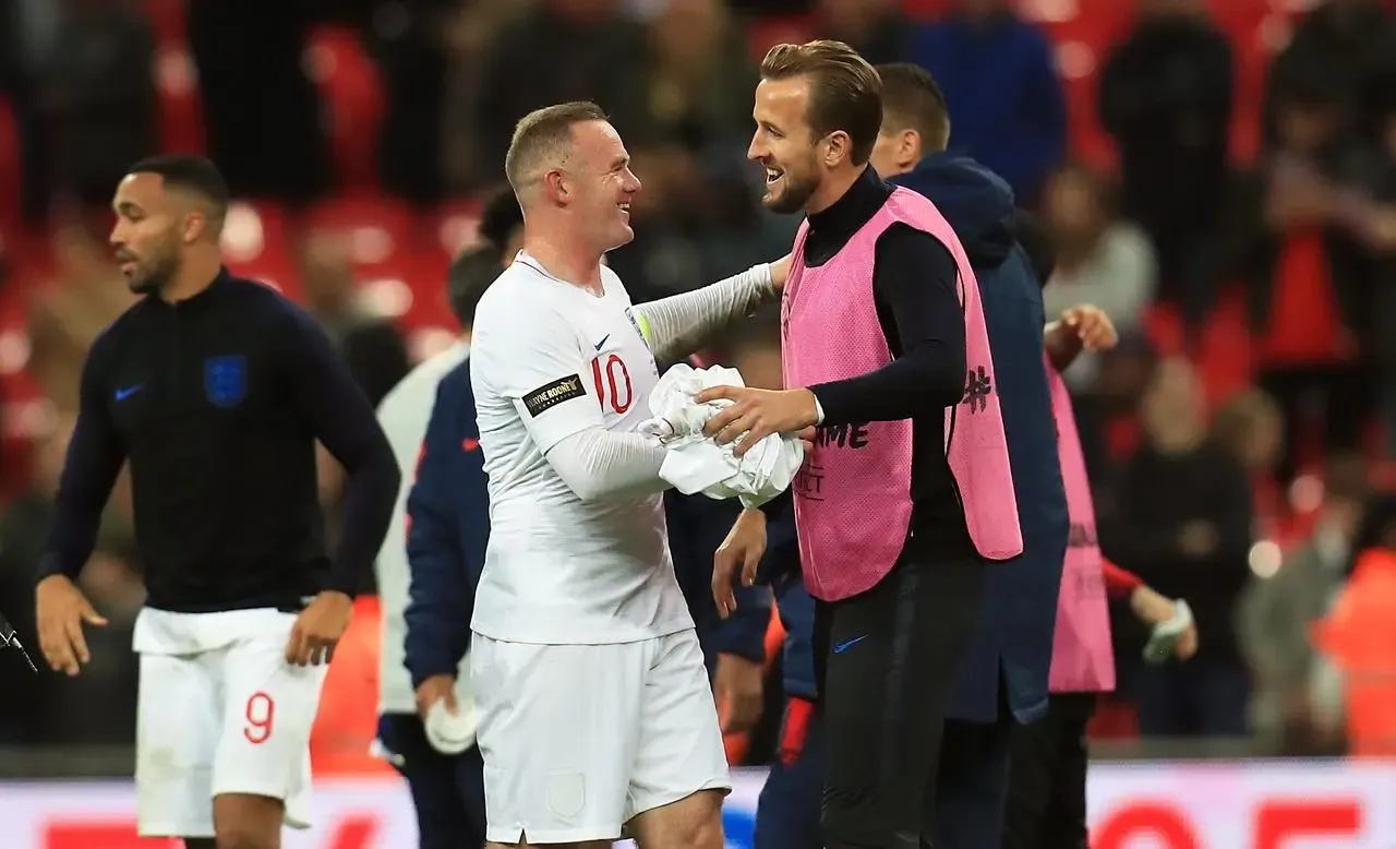 Wayne Rooney, left, and Harry Kane embrace after an England match