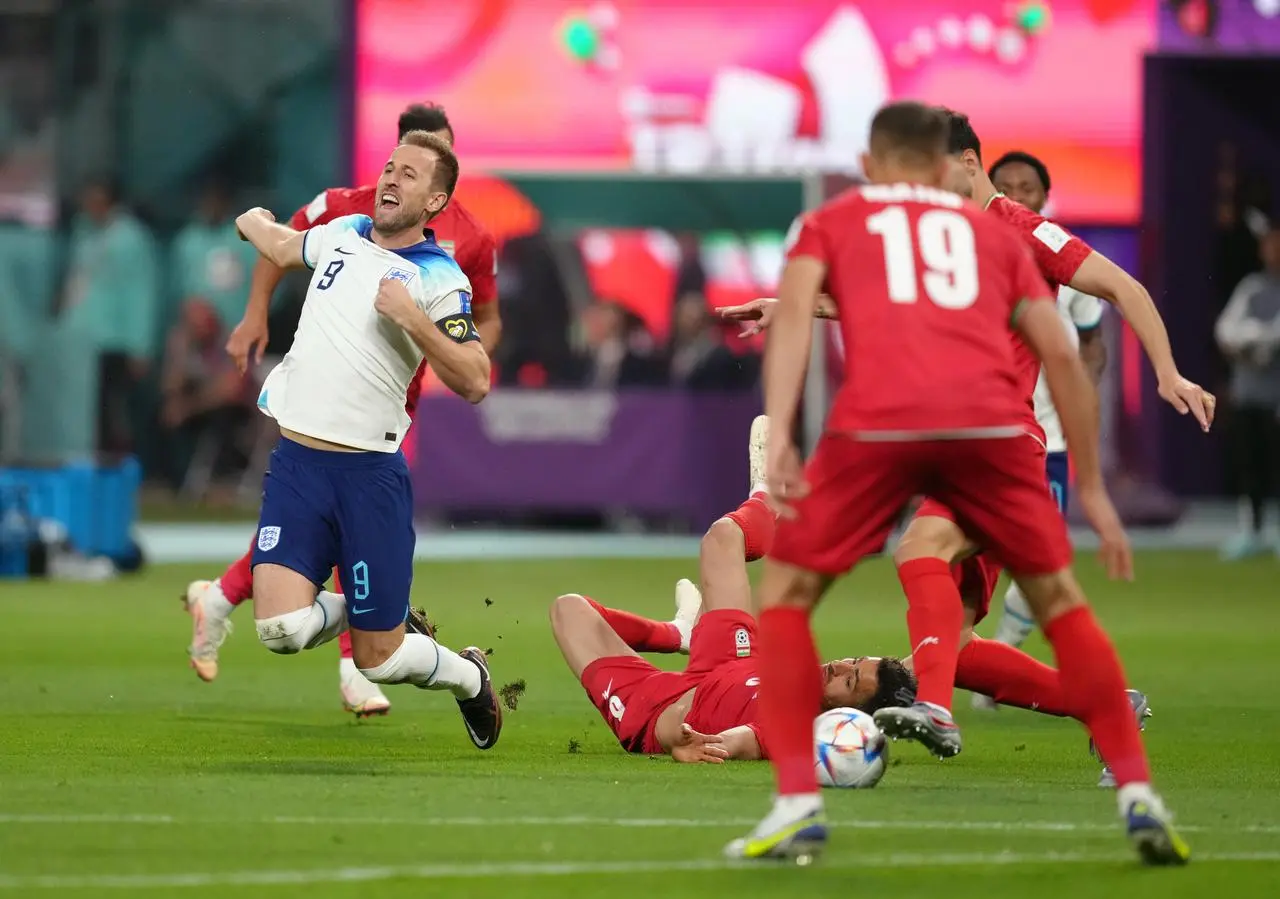 Harry Kane goes down after Morteza Pouraliganji's challenge