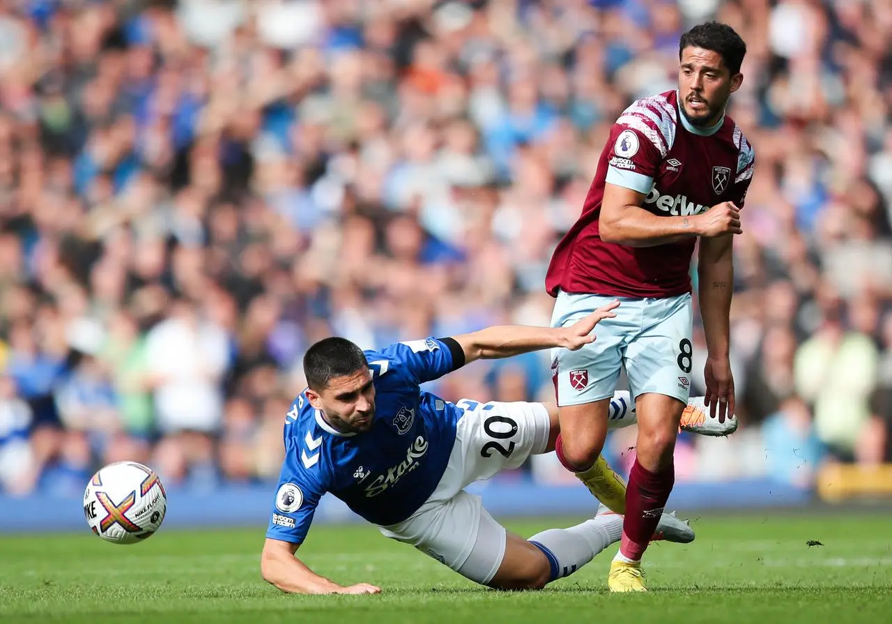 Everton striker Neal Maupay is tackled by West Ham's Pablo Fornals