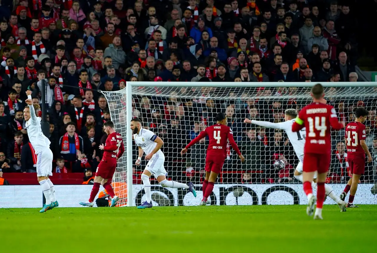 Karim Benzema, centre left, celebrates scoring Real Madrid’s fifth goal against Liverpool