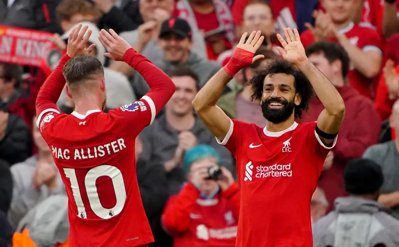 Mac Allister, left, celebrates Liverpool's third goal against Forest with scorer Mo Salah