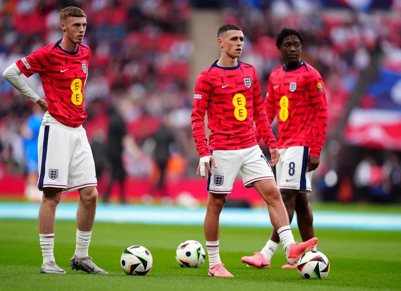 England’s Cole Palmer, Phil Foden and Kobbie Mainoo, left to right, warming up before the friendly against Iceland in June
