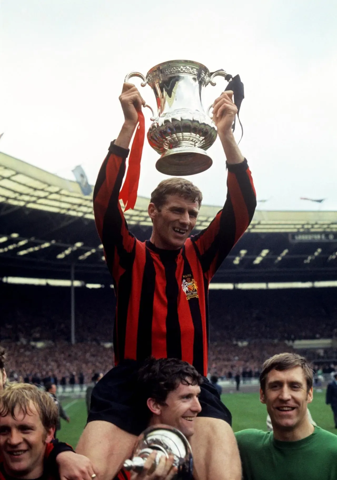 Tony Book is carried on Mike Doyle’s shoulders as Manchester City celebrate FA Cup success in 1969