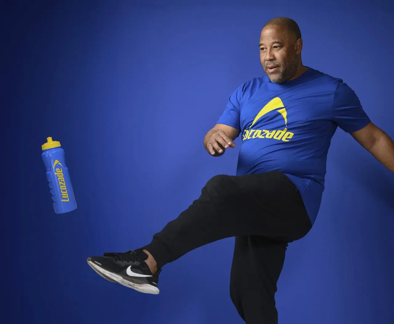 John Barnes kicks a Lucozade-branded drinks bottle of