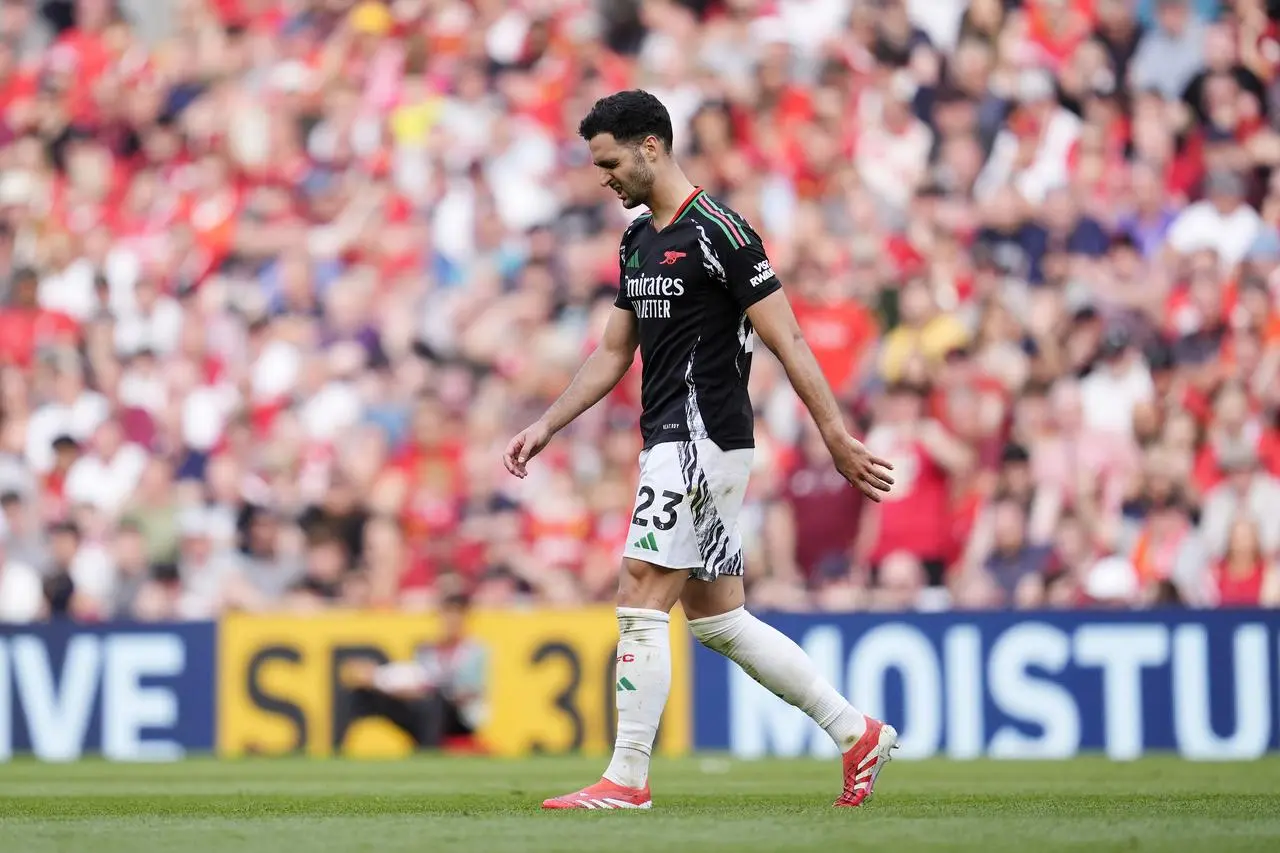 Arsenal’s Mikel Merino leaves the pitch at Anfield after being shown a red