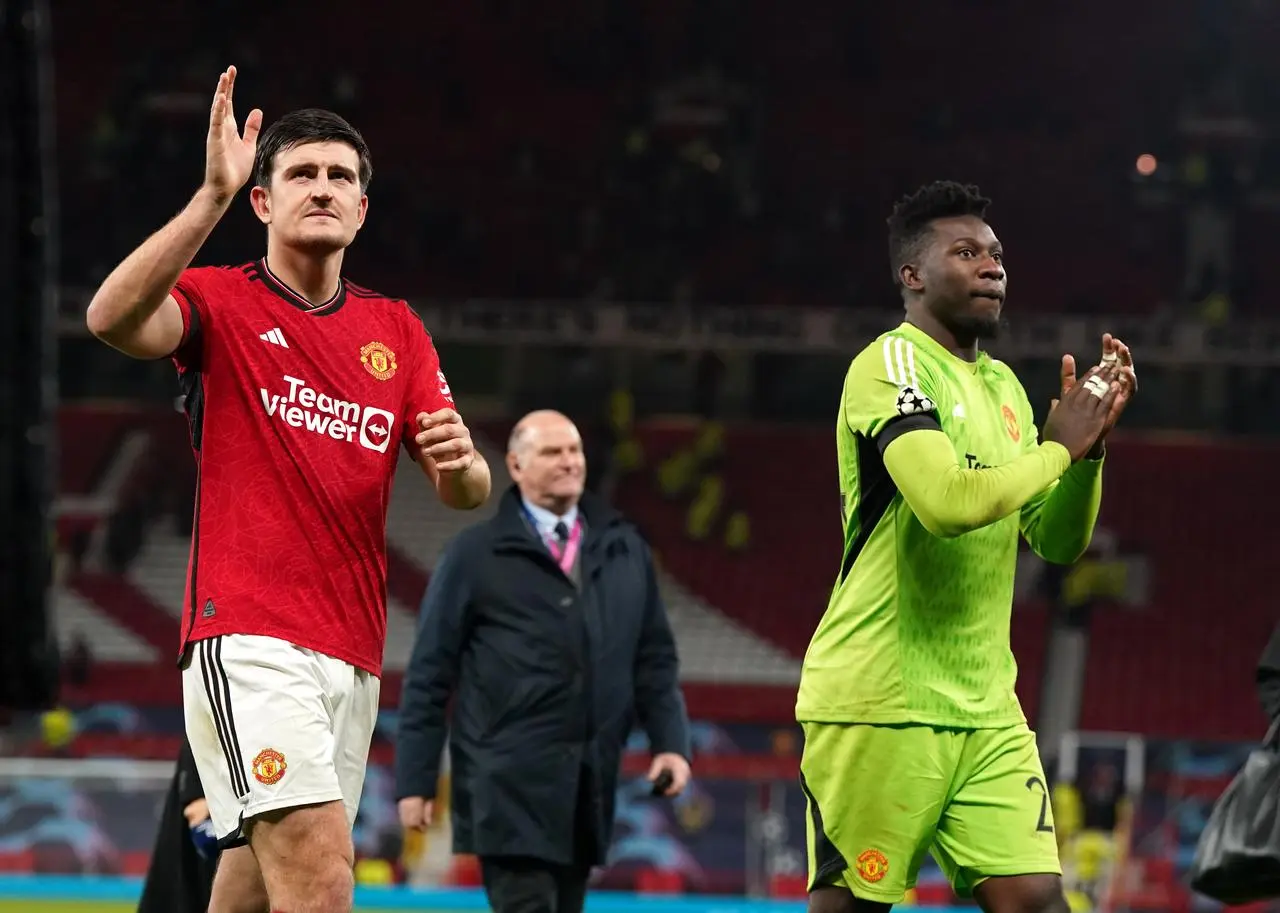 Manchester United’s Harry Maguire (left) and goalkeeper Andre Onana applaud supporters after a Champions League match against FC Copenhagen