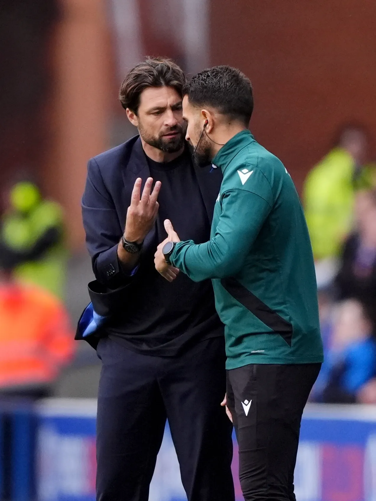Rangers manager Russell Martin, left, speaks with the fourth official
