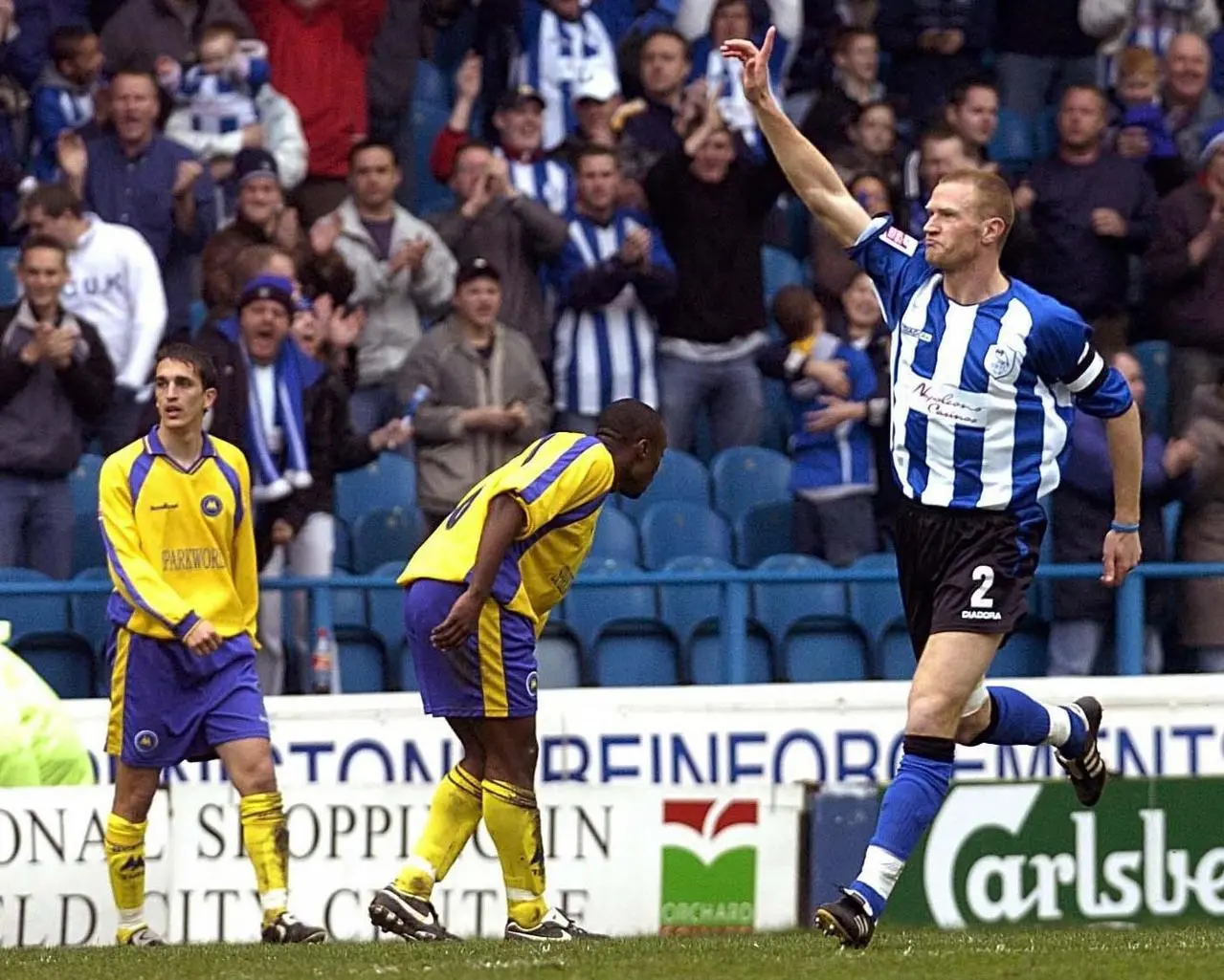 Sheffield Wednesday’s Lee Bullen, right, celebrates scoring against Torquay