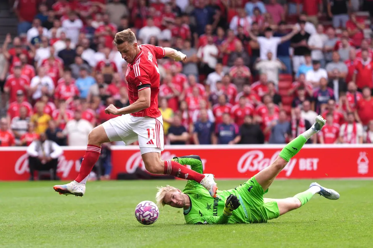 Chris Wood, left, gets past Brentford goalkeeper Caoimhin Kelleher
