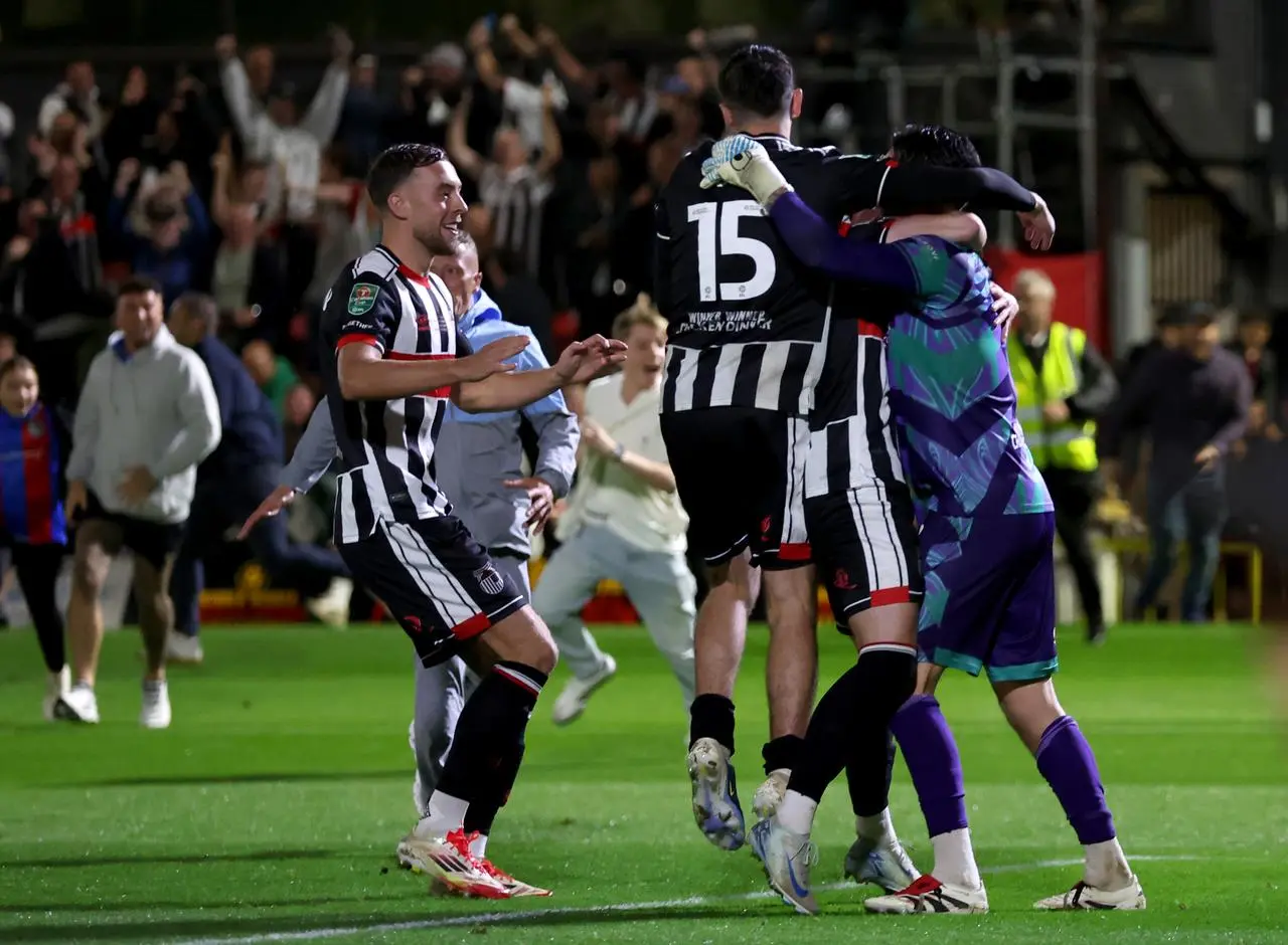 Grimsby players celebrate their Carabao Cup win against Manchester United