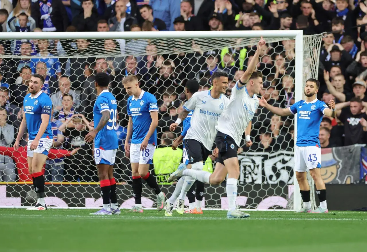 Club Brugge players celebrate as Rangers players look on