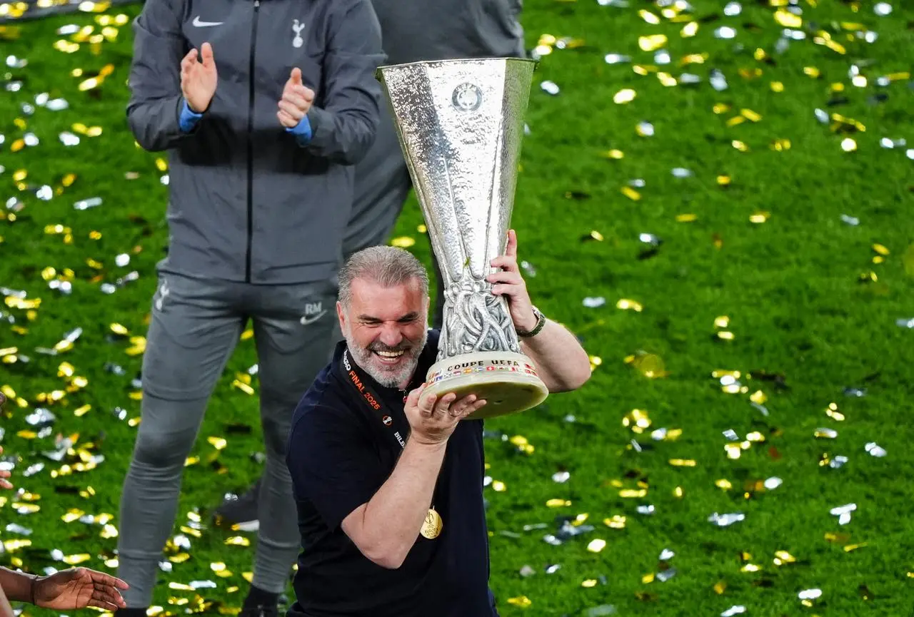 Ange Postecoglou lifts the Europa League trophy after Tottenham's win in the final against Manchester United