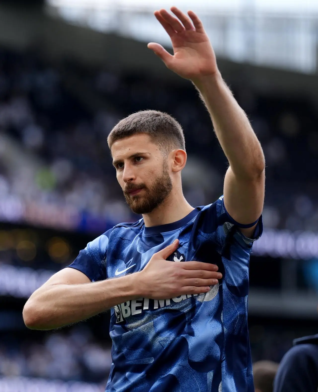 Tottenham Hotspur goalkeeper Guglielmo Vicario puts his hand on his heart as he waves to the fans after last season's Premier League defeat to Brighton