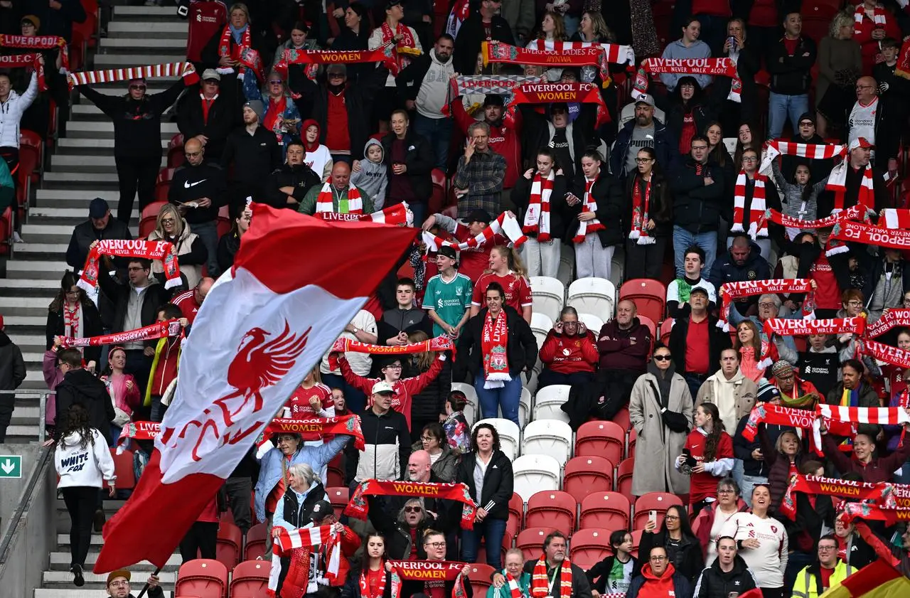 Liverpool fans hold up scarfs while singing ‘You’ll Never Walk Alone’ before a Women’s Super League match at the Totally Wicked Stadium in St Helens