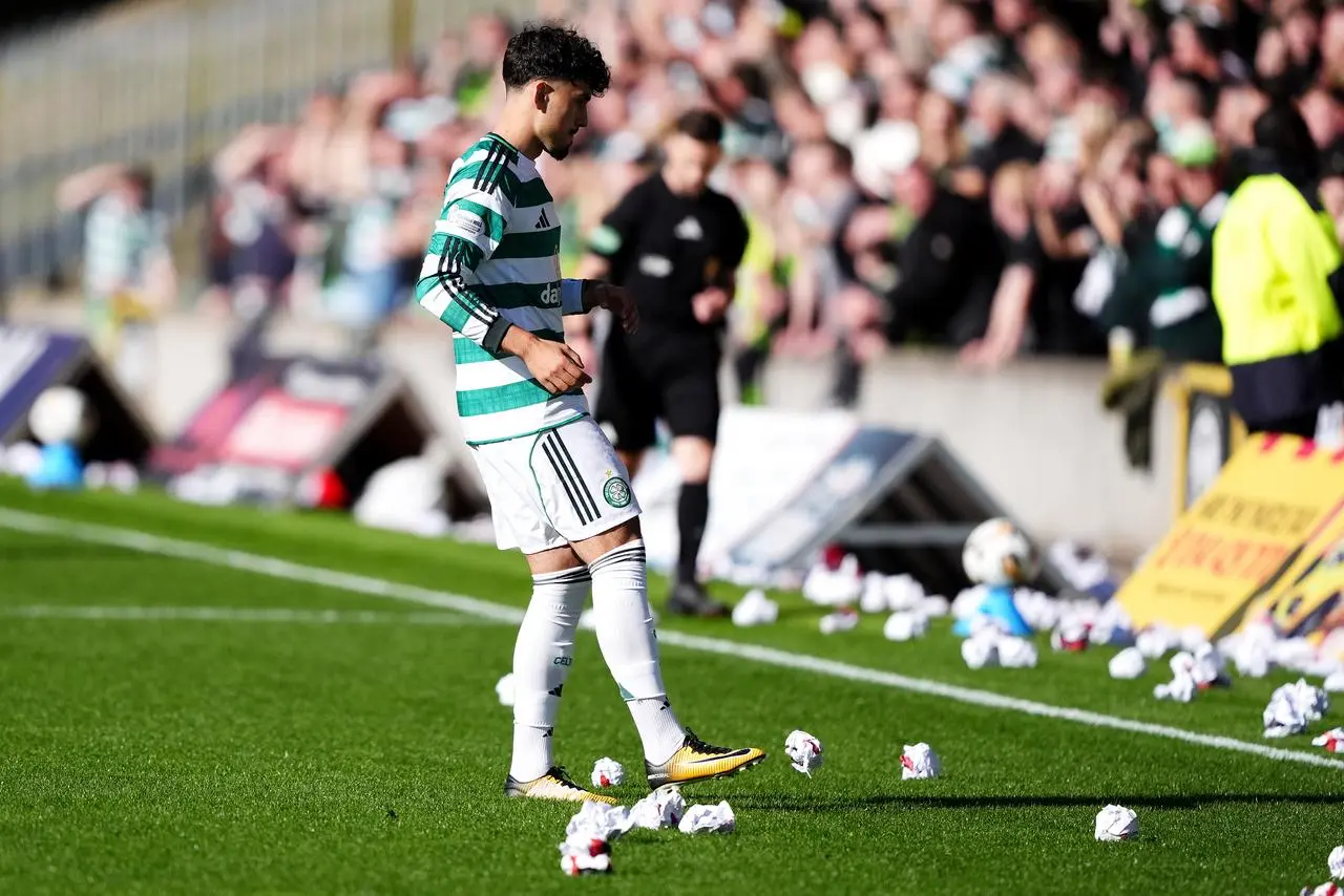 Celtic’s Sebastian Tounekti kicks anti-board posters off the pitch at Firhill