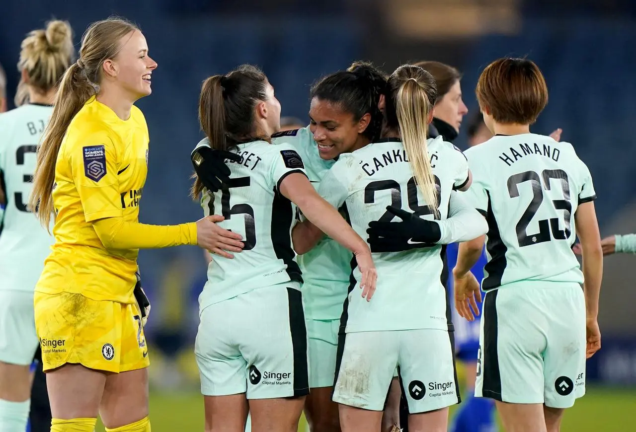 Chelsea’s Catarina Macario, centre, is congratulated by team mates after scoring on her debut