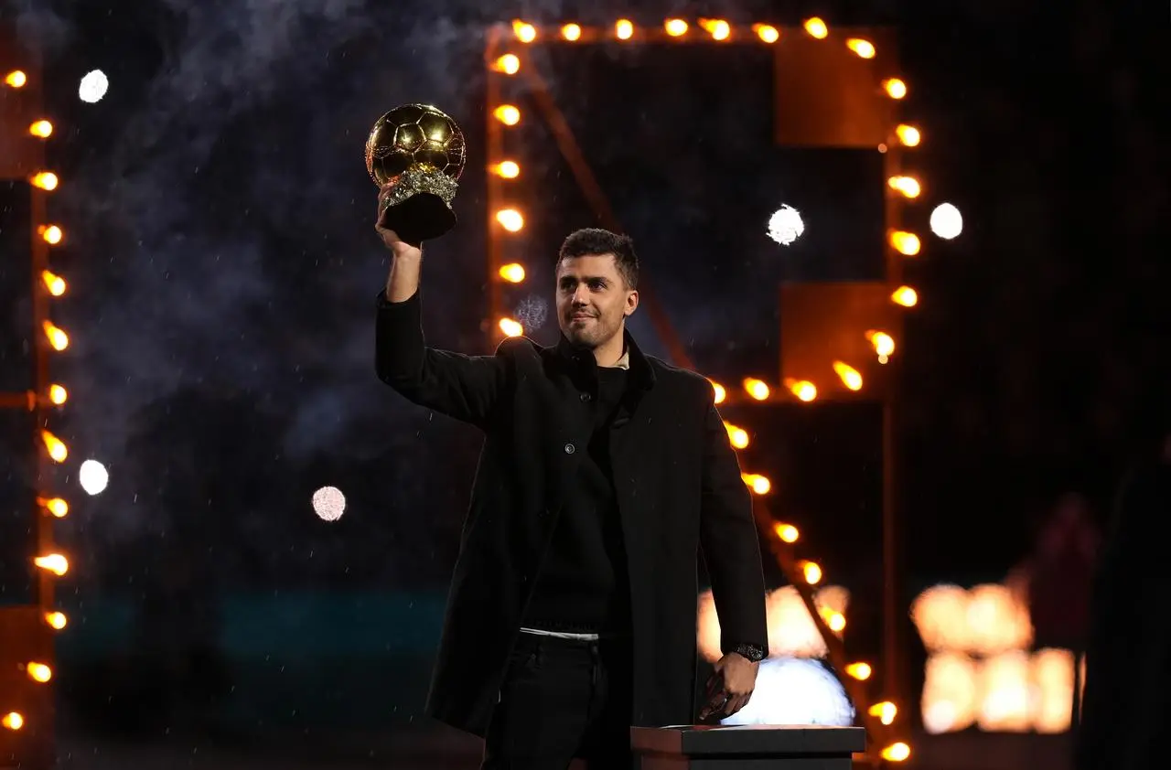 Manchester City's Rodri holds up the Ballon d'Or
