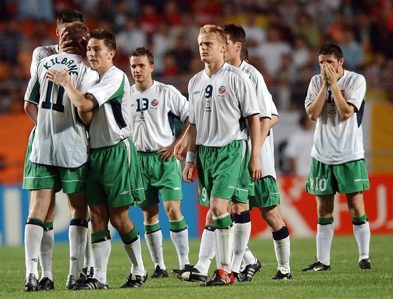Republic of Irelandâs Kevin Kilbane (number 11) is consoled by team-mates after missing a penalty against Spain in Suwon at the 2002 World Cup finals