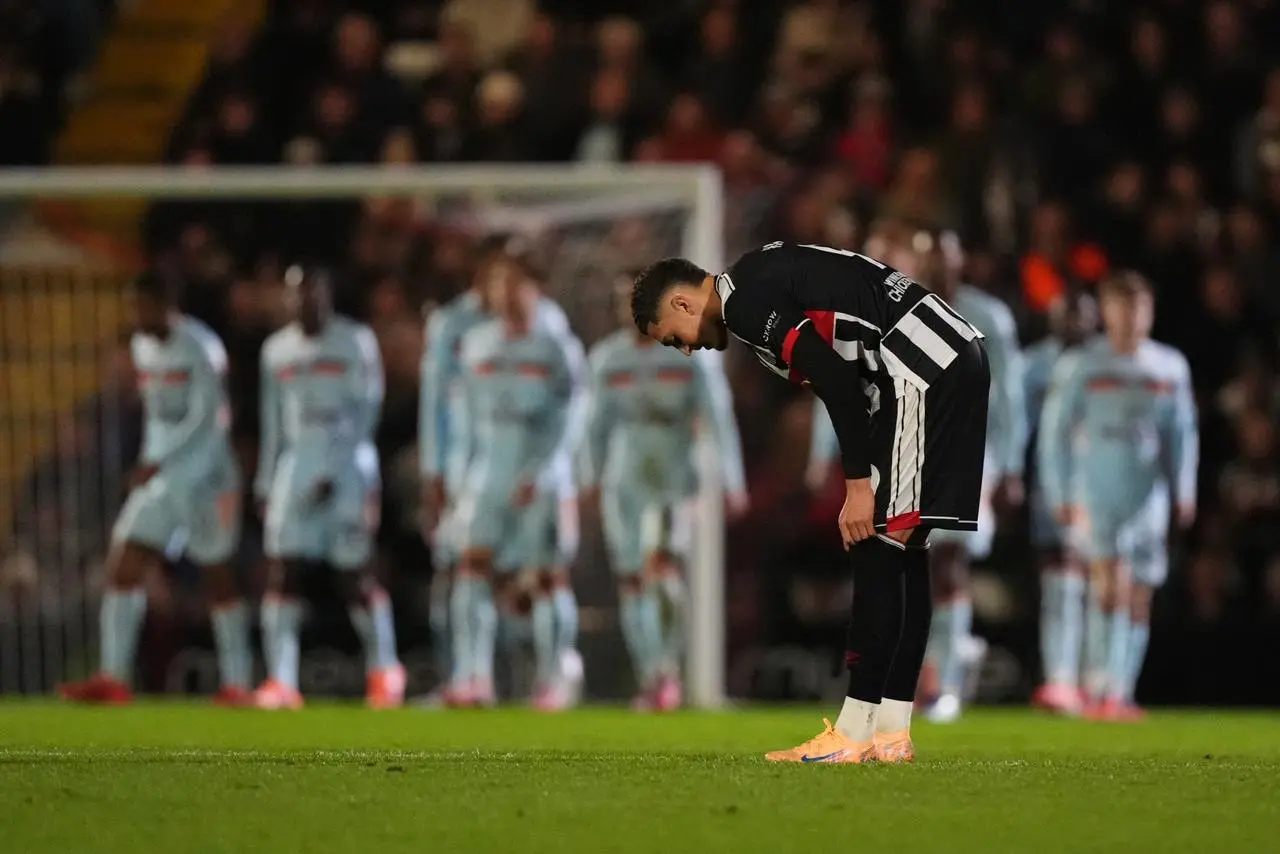 Grimsby Town’s Jaze Kabia adjusts his socks