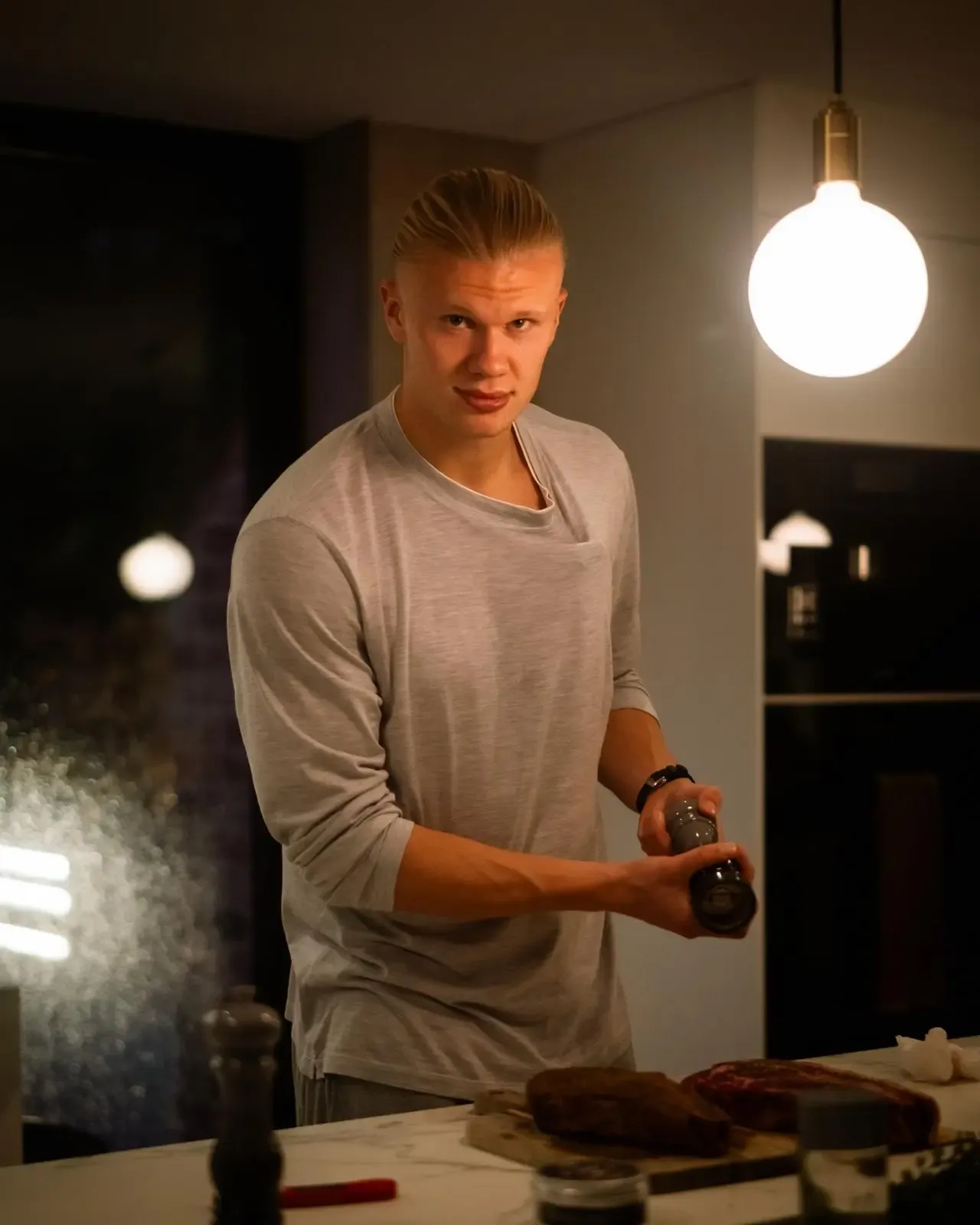 Erling Haaland prepares steak in his kitchen at home