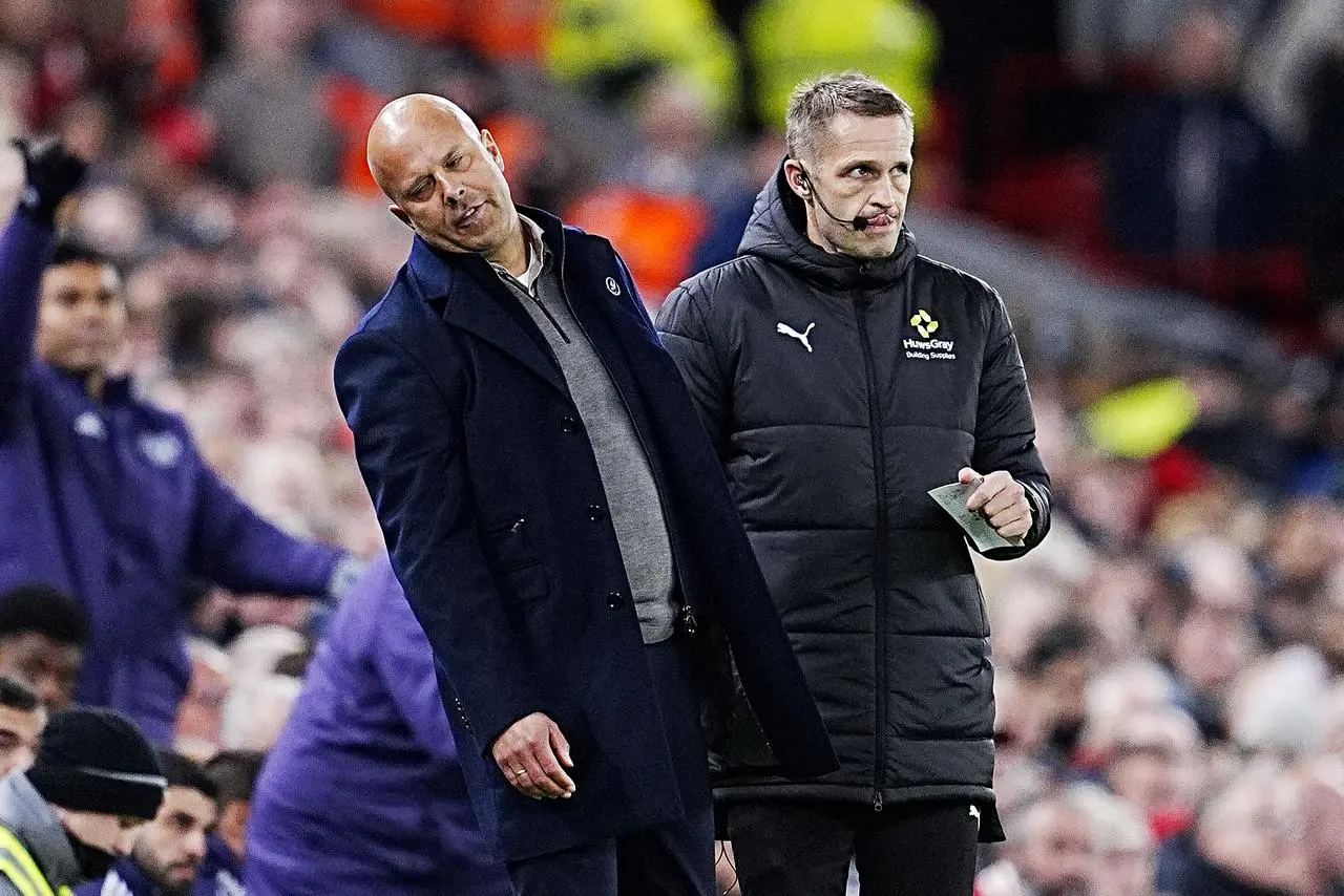 Liverpool manager Arne Slot, left, reacts on the touchline during Sunday's defeat to Manchester United