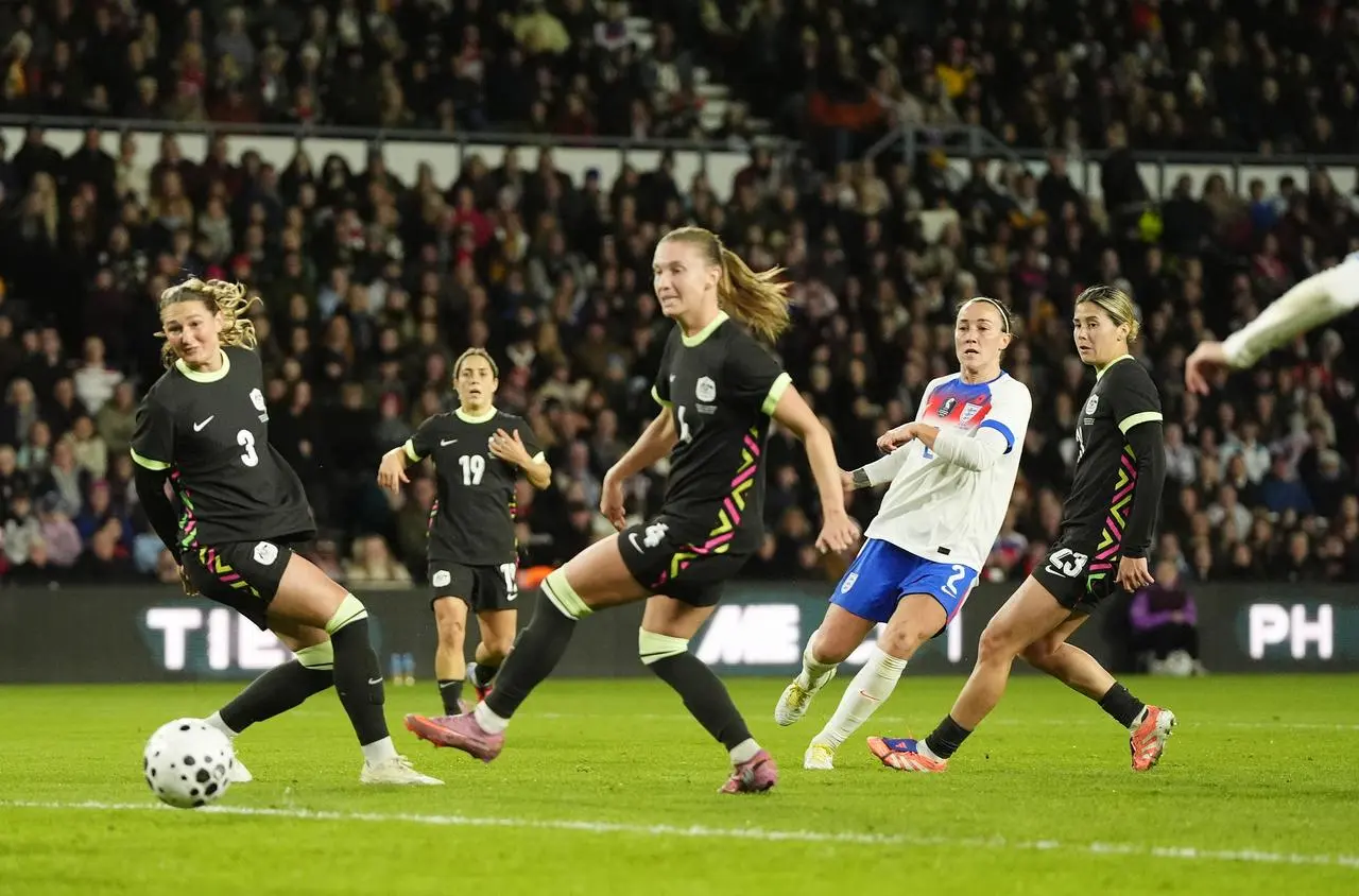 Lucy Bronze, second right, scores England’s second goal