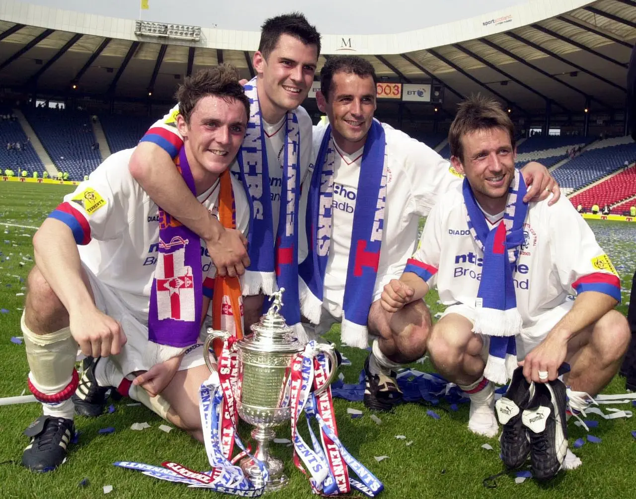 Former Rangers player Kevin Muscat poses with team-mates