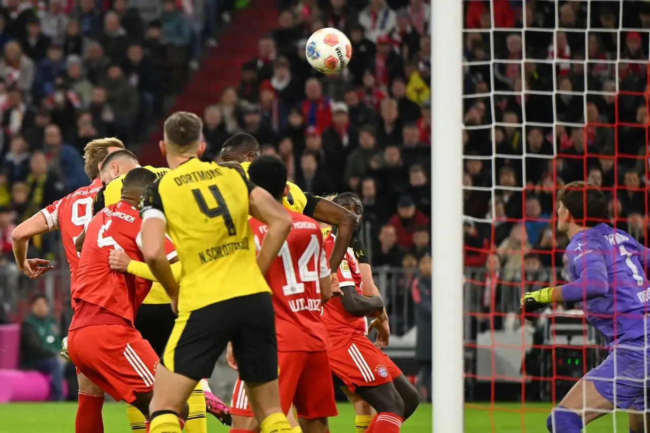 Harry Kane (left) scores for Bayern Munich against Borussia Dortmund