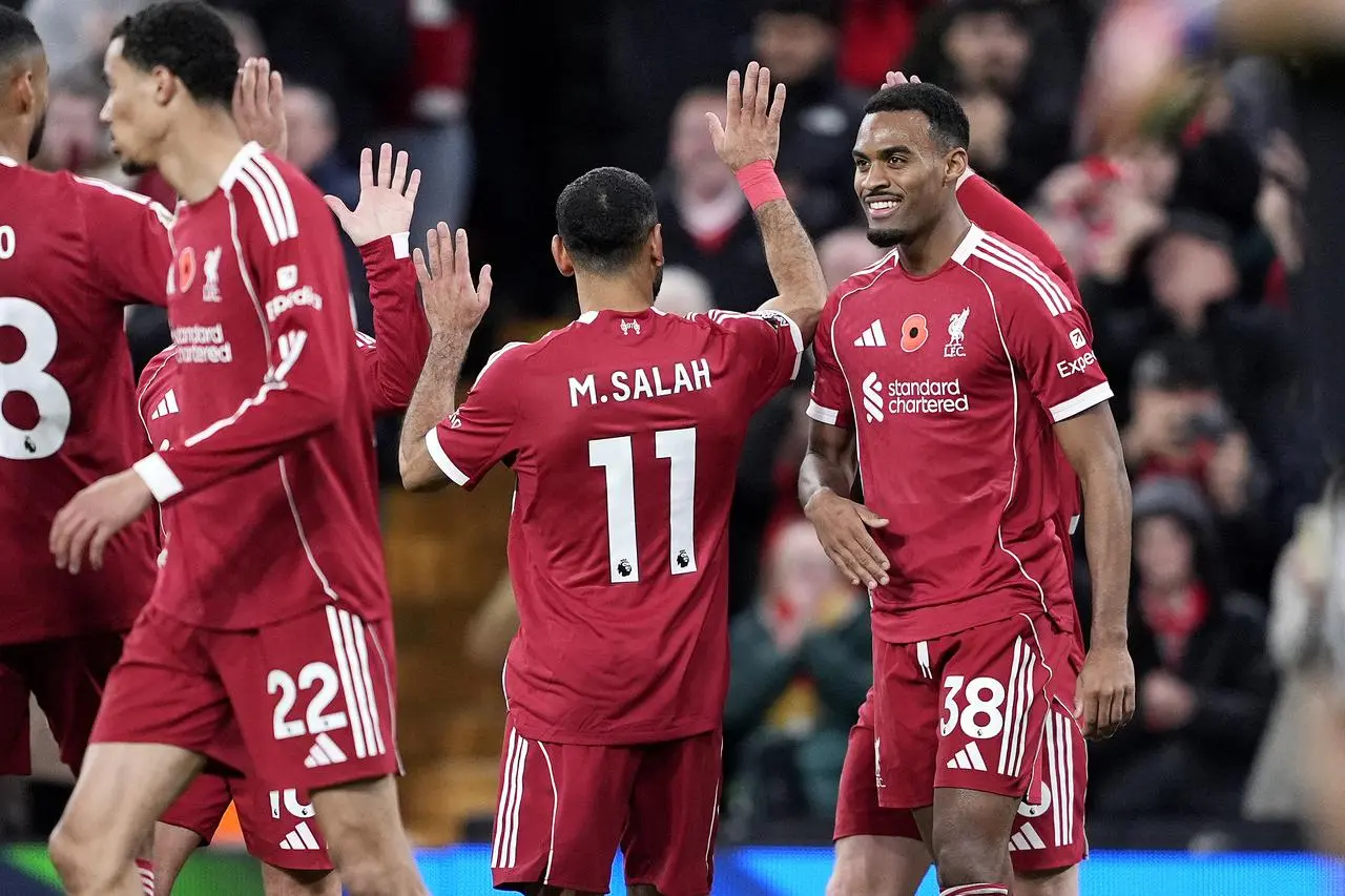 Mohamed Salah, second right, and Ryan Gravenberch, right, celebrate