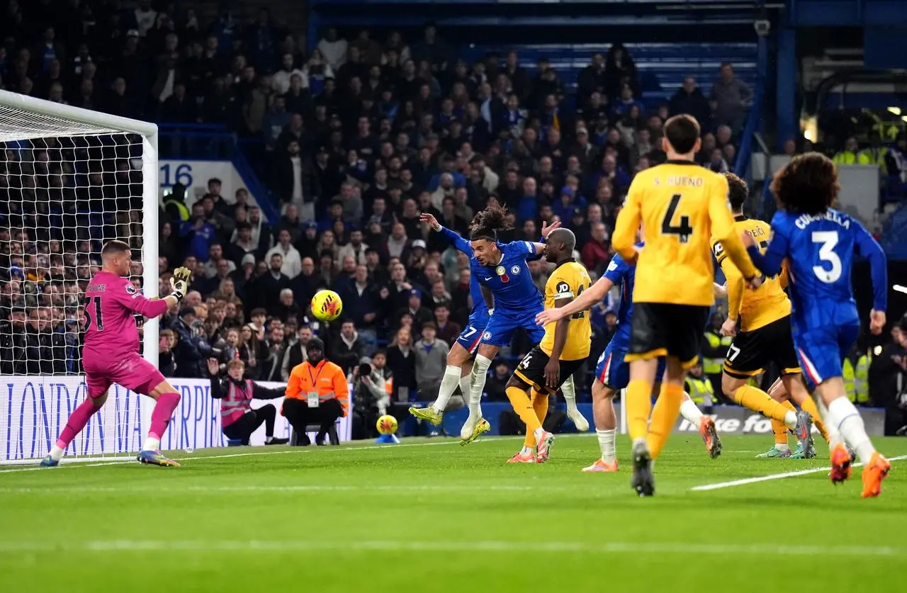Malo Gusto, centre, heads Chelsea in front against Wolves