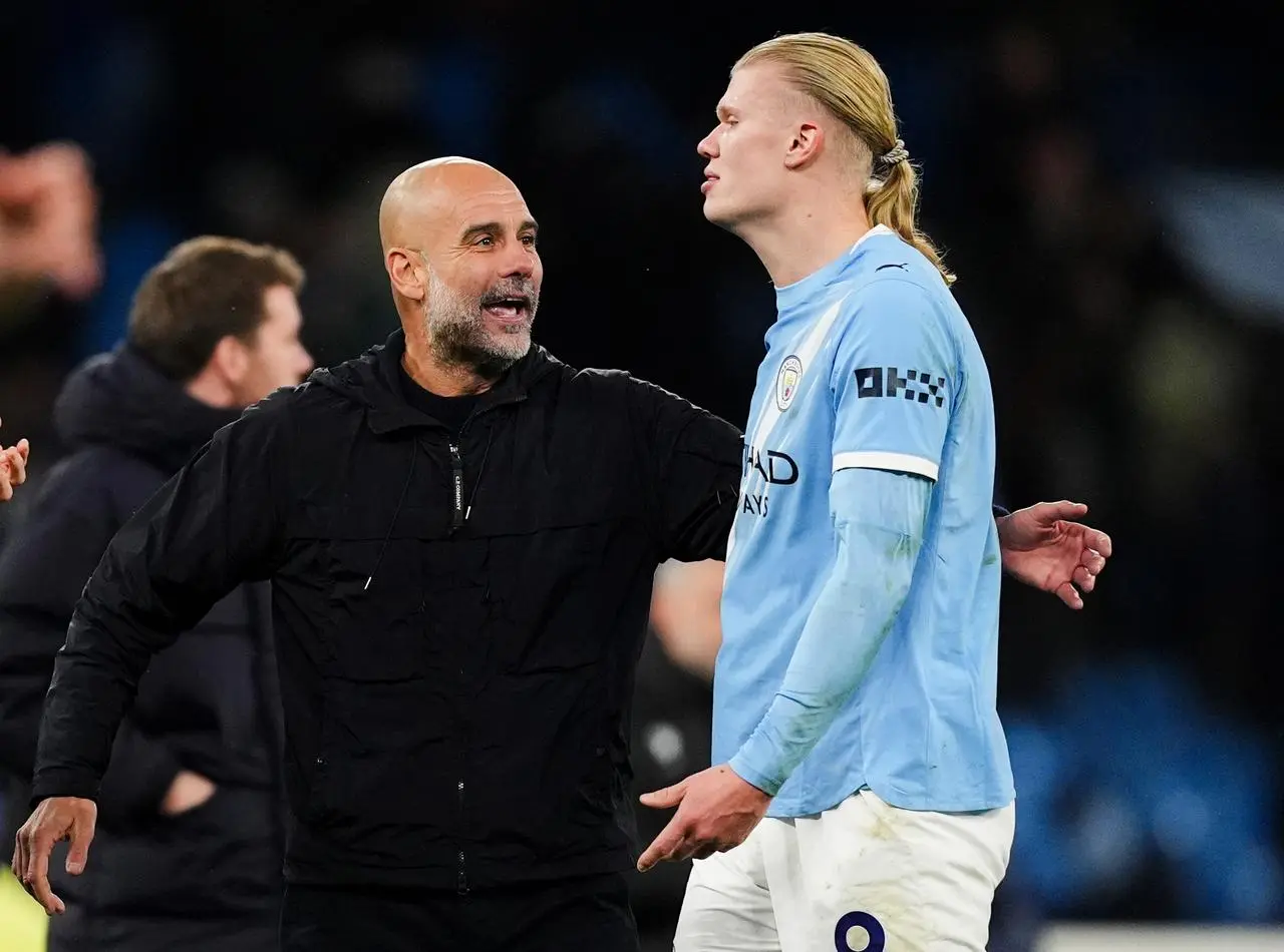 Manchester City manager Pep Guardiola with Erling Haaland following the late victory