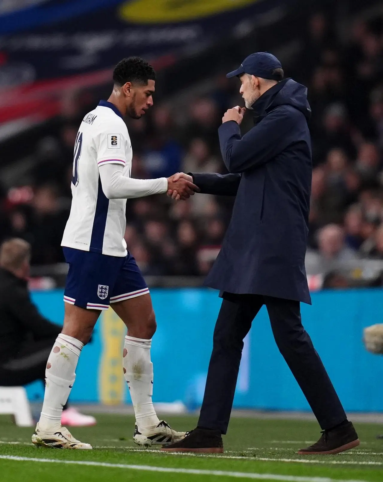 England manager Thomas Tuchel shakes hands with Jude Bellingham as he is substituted against Latvia