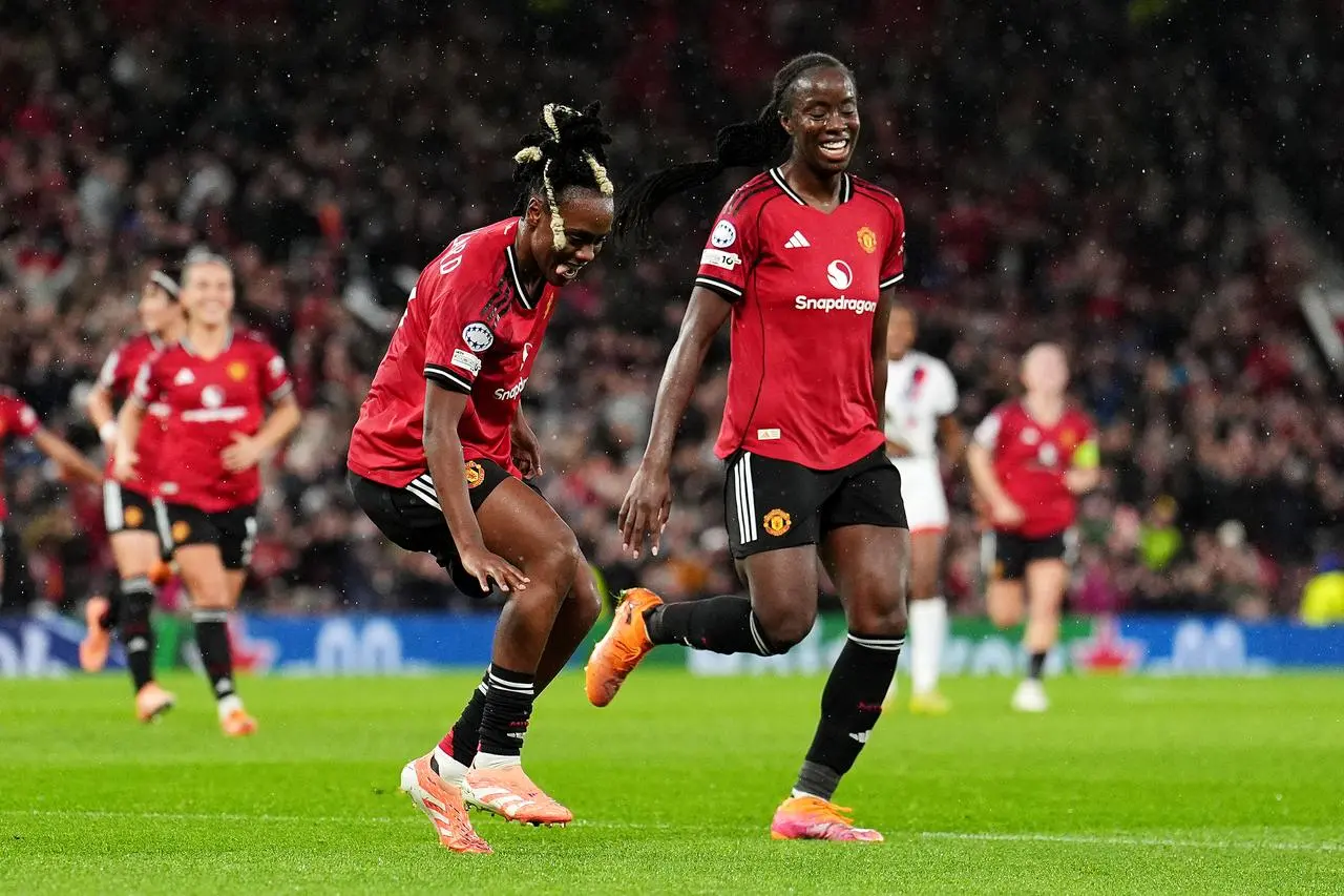 Melvine Malard, centre left, celebrates her goal