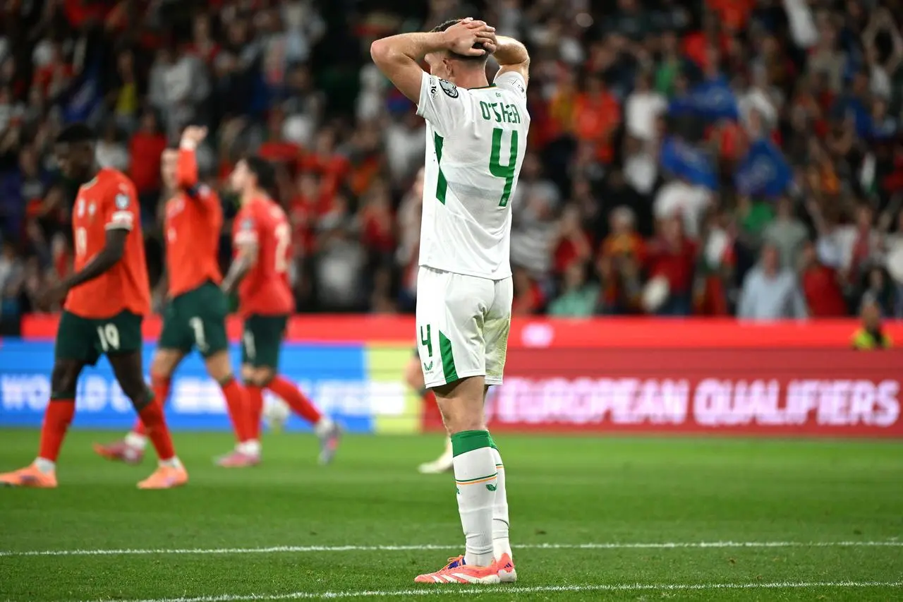 Republic of Ireland defender Dara O’Shea looks dejected following defeat in the World Cup qualifier in Portugal