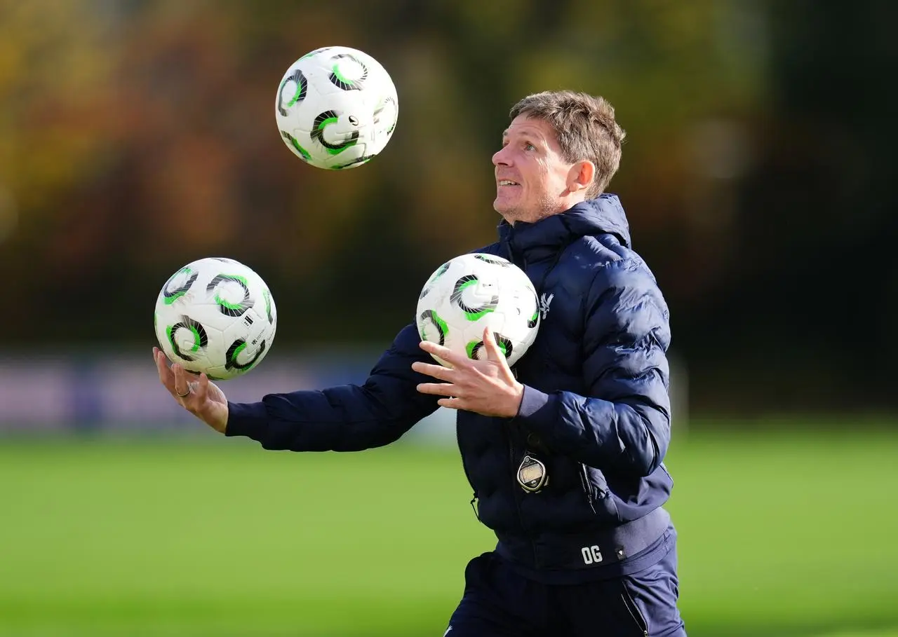 Crystal Palace manager Oliver Glasner juggles three footballs during a training session