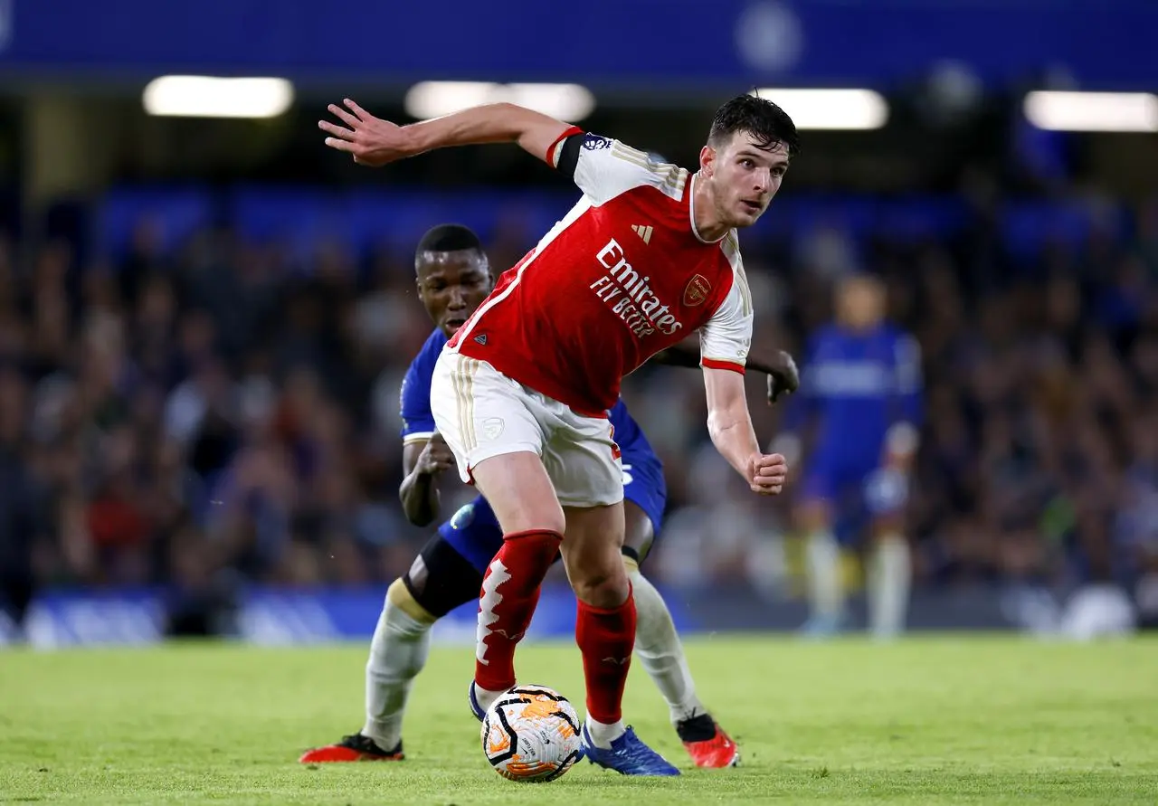 Arsenal’s Declan Rice, front, dribbles away from Chelsea’s Moises Caicedo