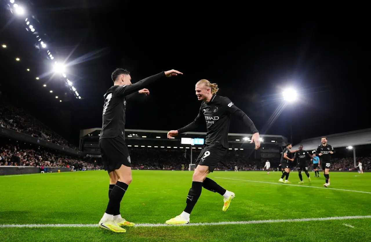 Manchester City’s Phil Foden (left) celebrates scoring his sides fourth goal with Erling Haaland