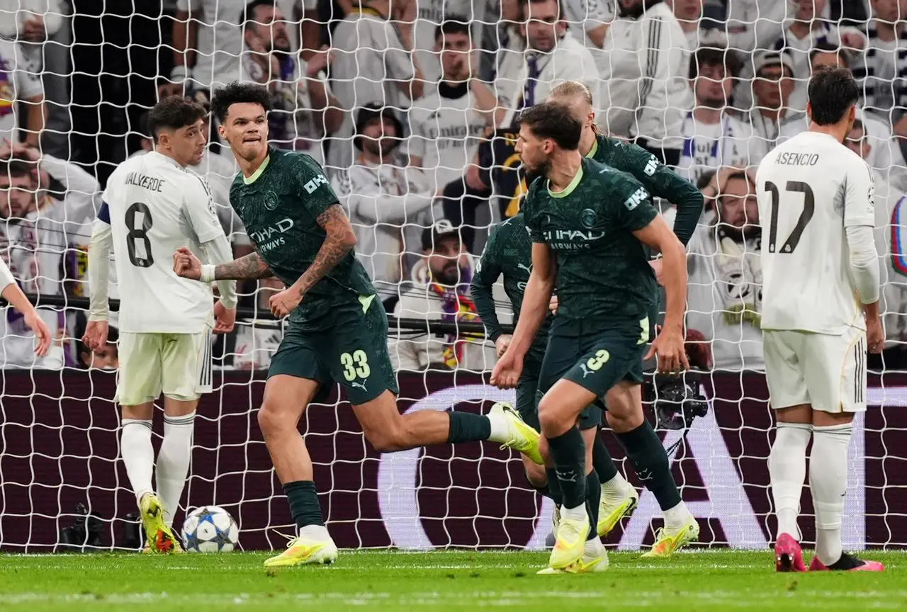 Manchester City’s Nico O’Reilly, left, celebrates his equaliser against Real Madrid