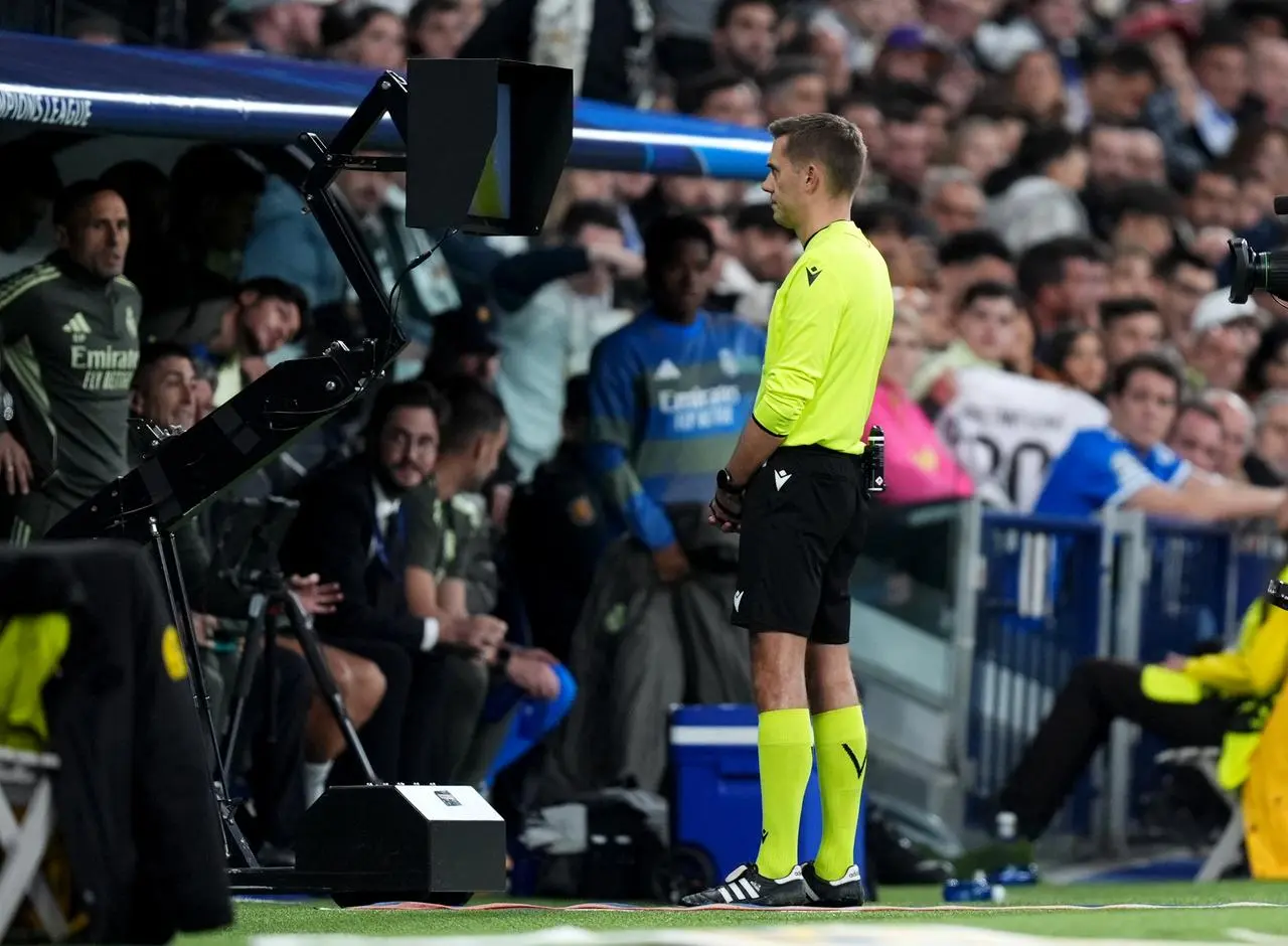 Referee Clement Turpin checks the VAR screen