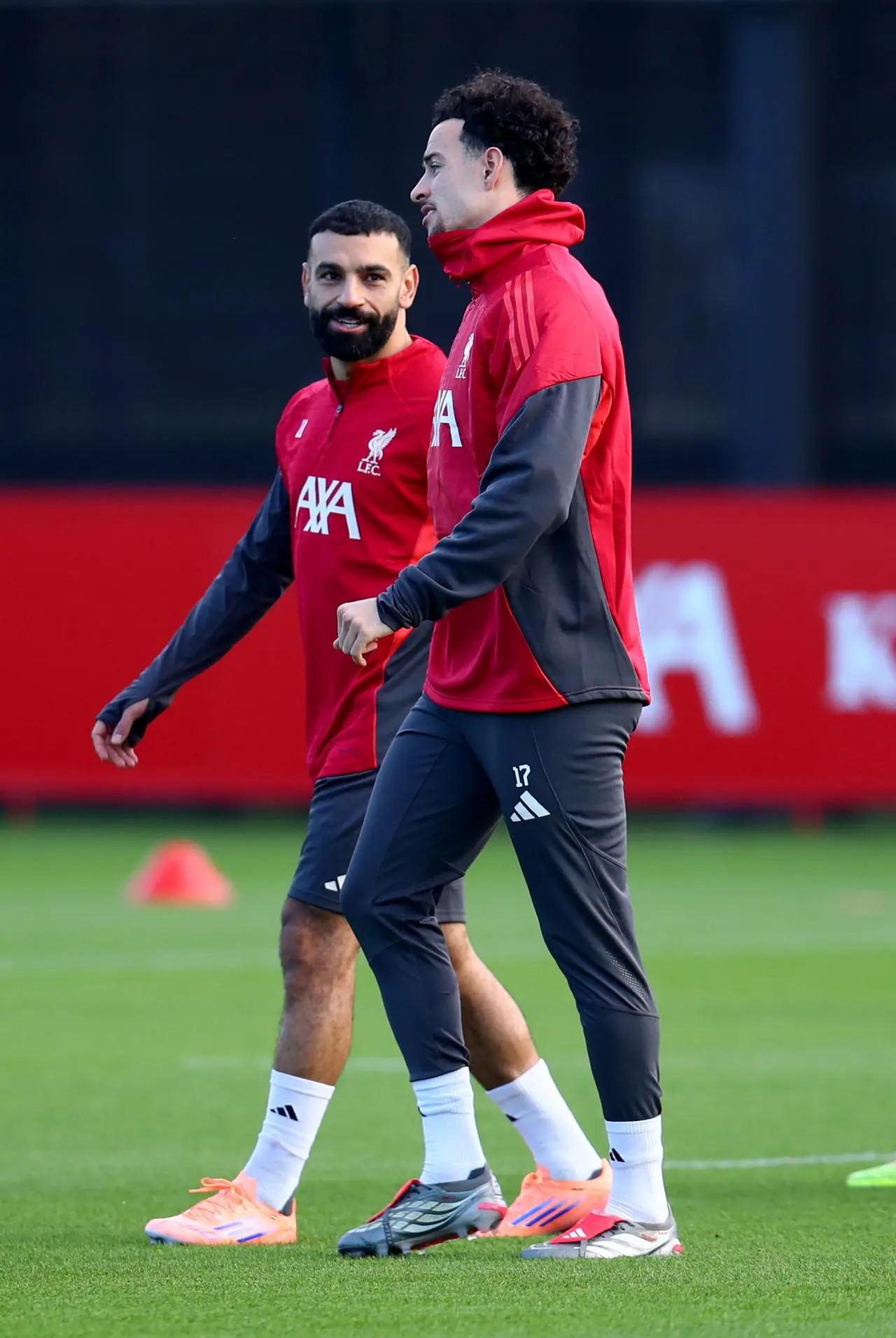 Liverpool’s Mohamed Salah, left, talks to Curtis Jones during a training session
