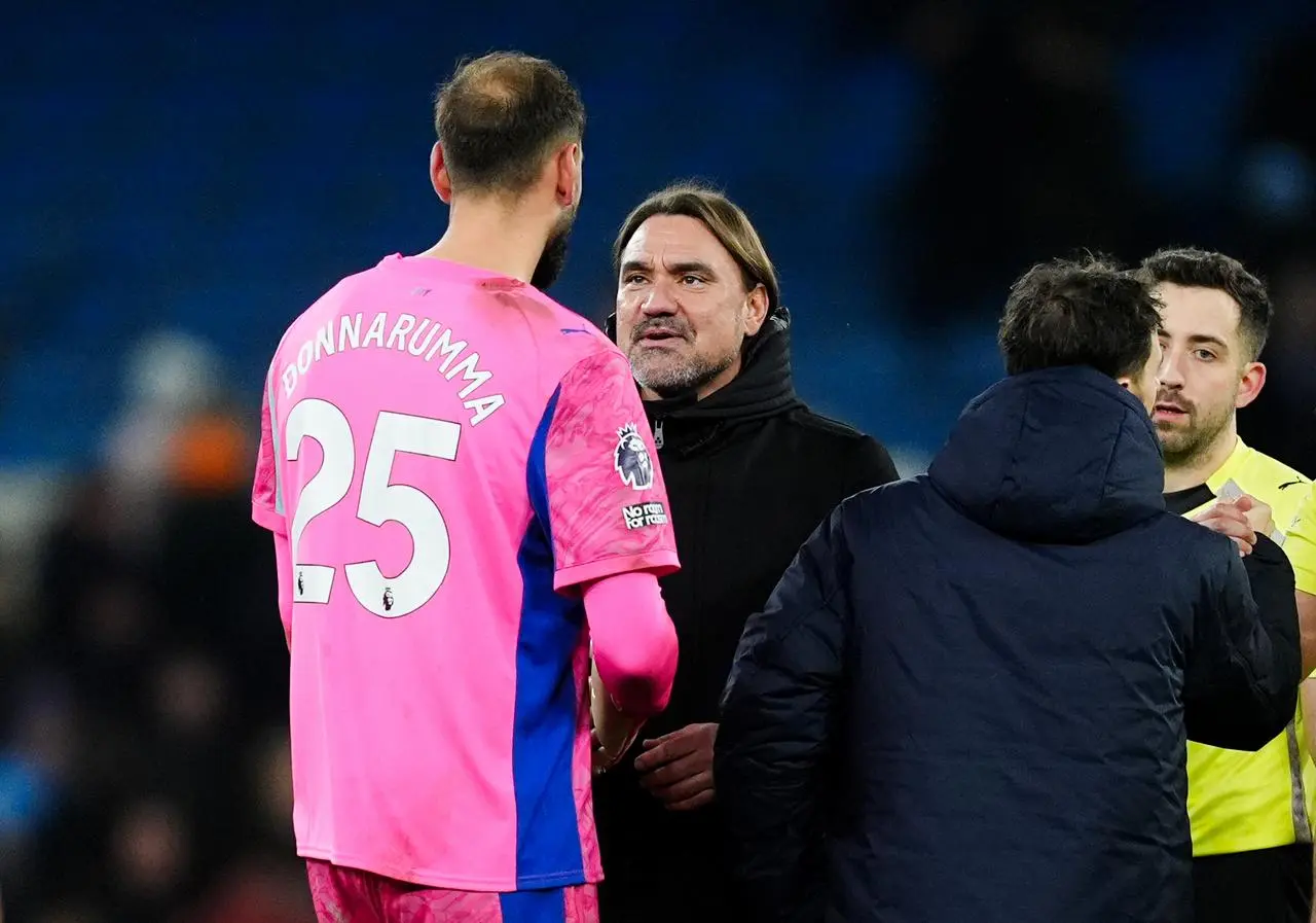 Leeds United manager Daniel Farke speaks with Manchester City goalkeeper Gianluigi Donnarumma after a game