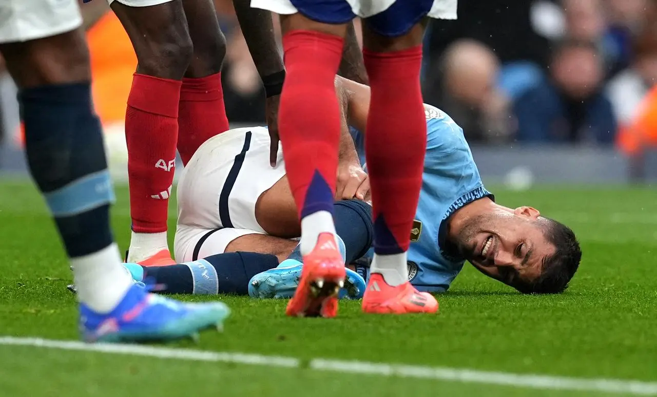 Manchester City’s Rodri lies injured on the field