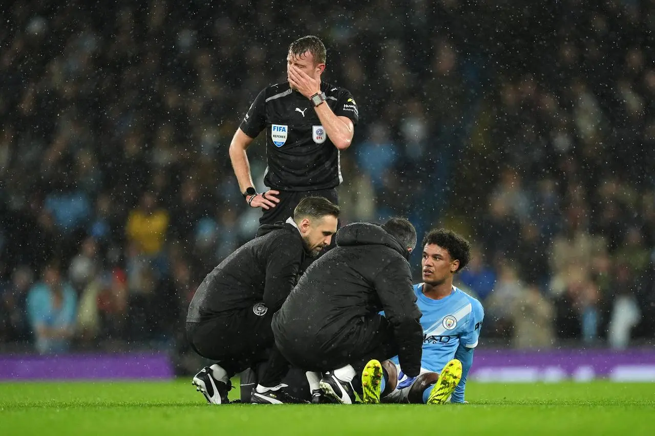 Oscar Bobb receives medical treatment before being substituted