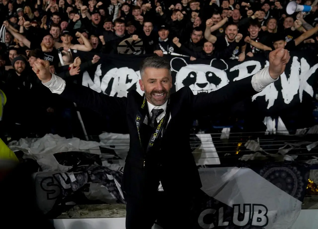 Stephen Robinson celebrates in front of the St Mirren fans