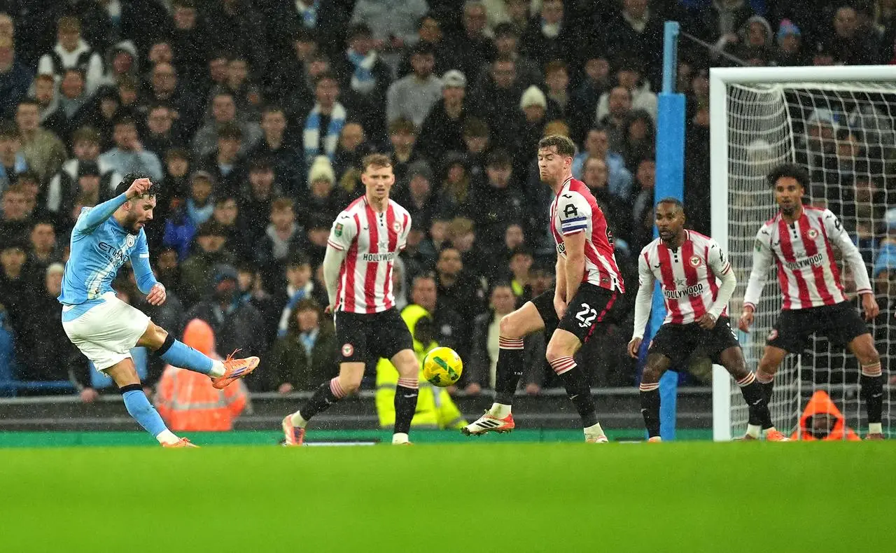 Rayan Cherki (left) scores