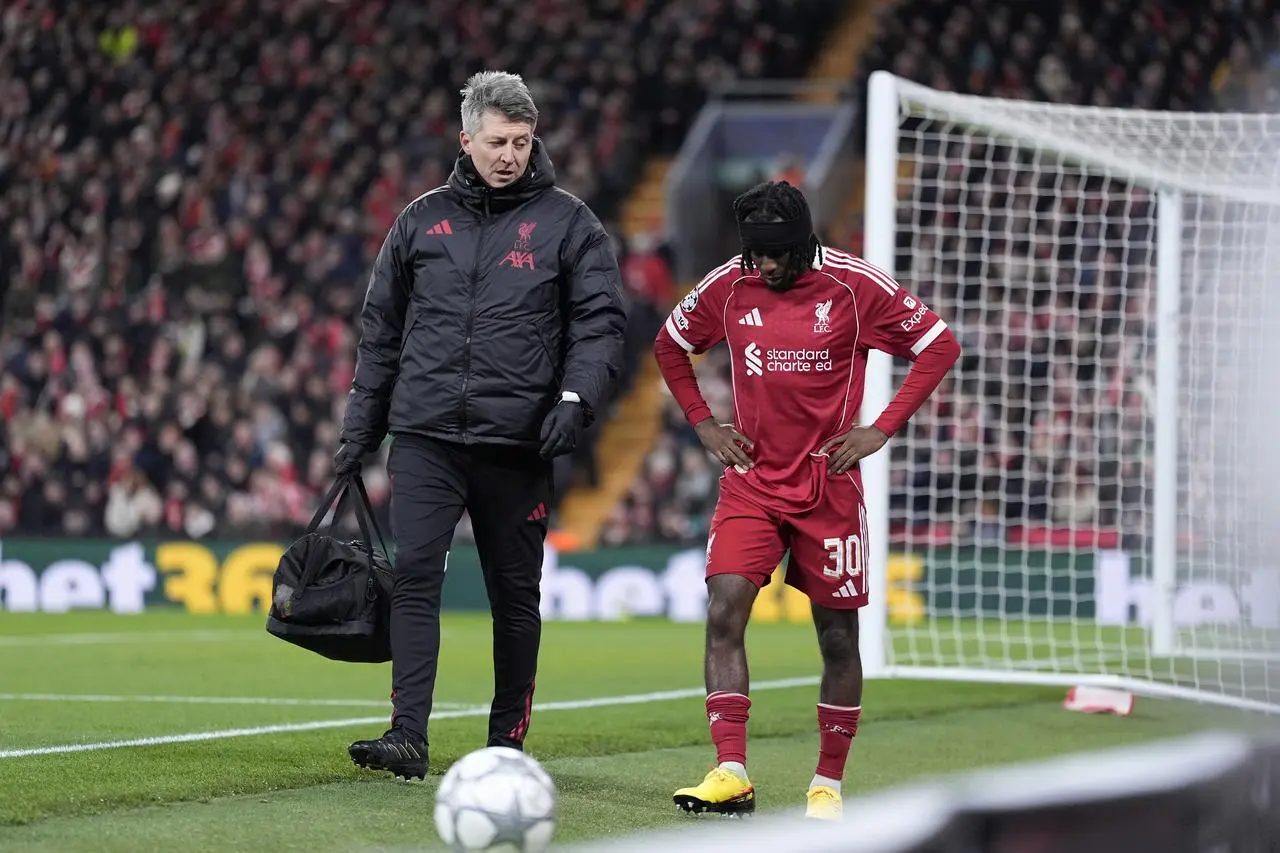Liverpool’s Jeremie Frimpong looks dejected after going off injured