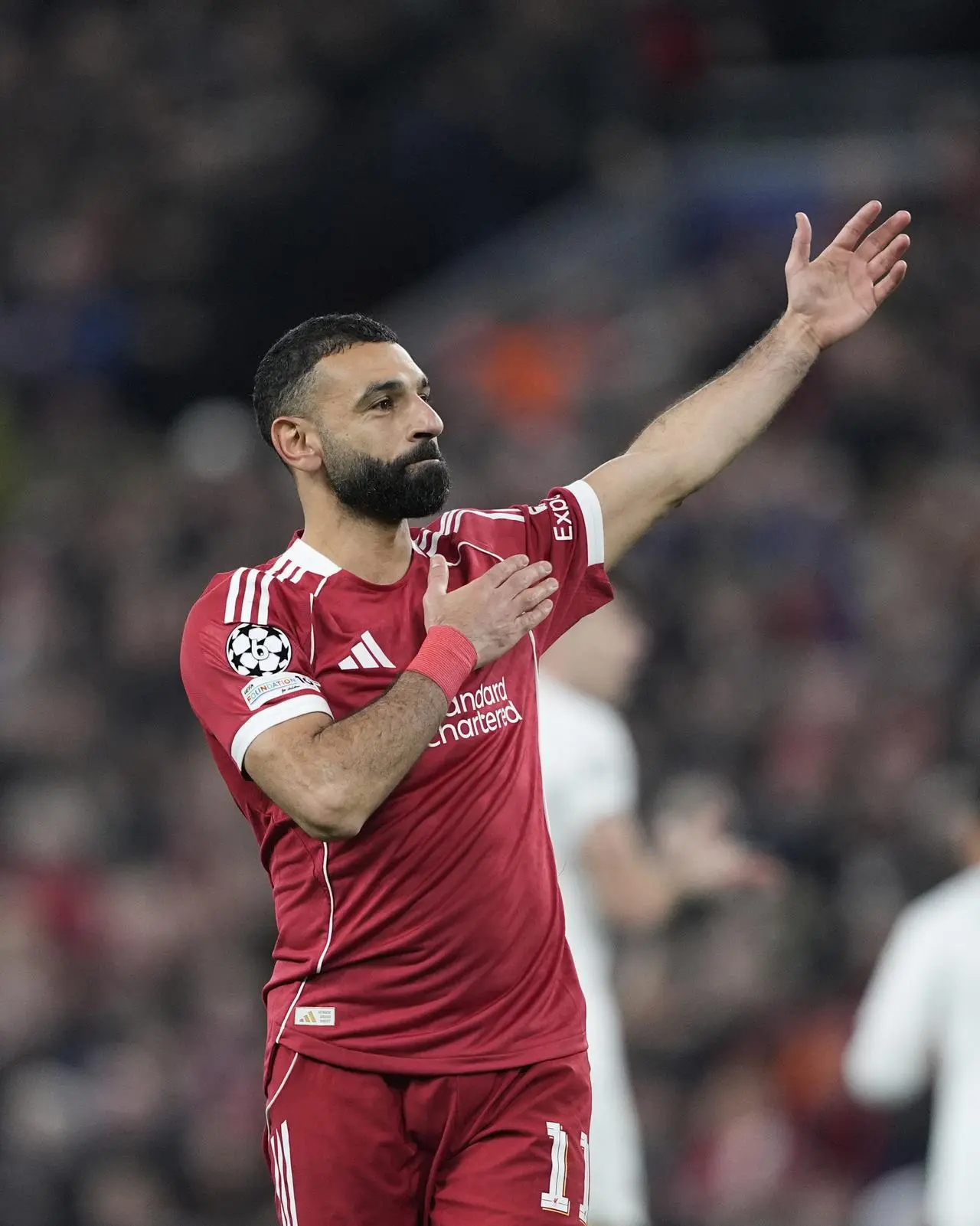 Liverpool’s Mohamed Salah taps the badge after scoring