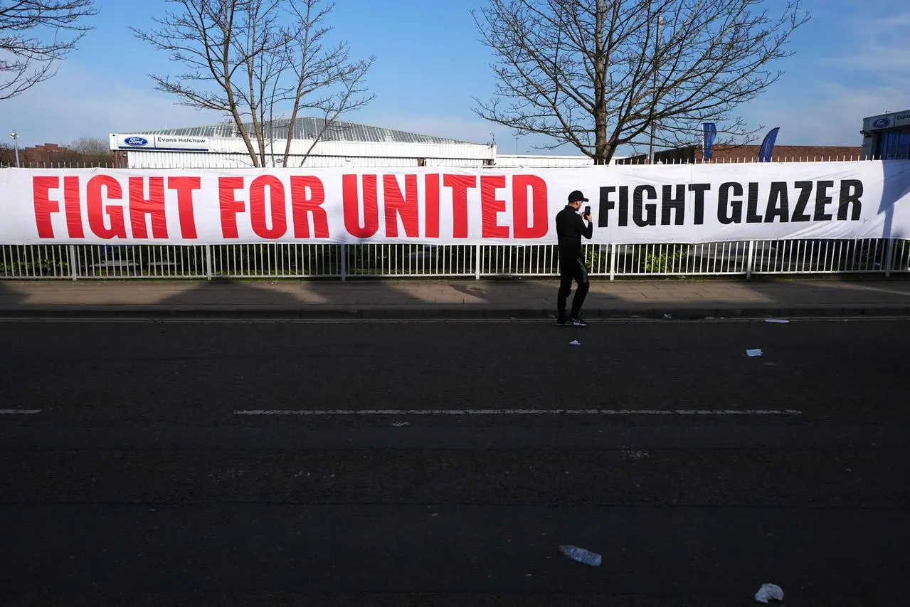 A general view of a large sign saying ‘FIGHT FOR UNITED FIGHT GLAZER’