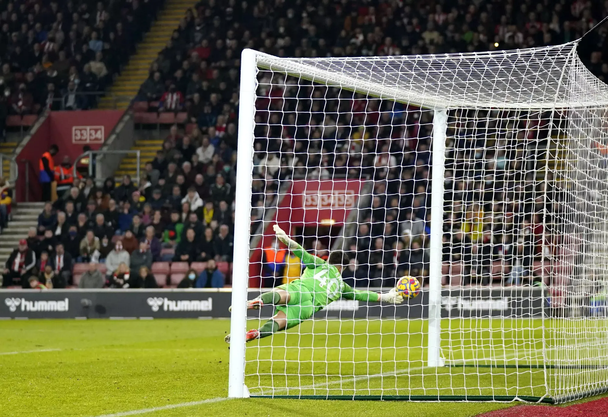 Alvaro Fernandez dives to his right before the ball deflects back off the post 