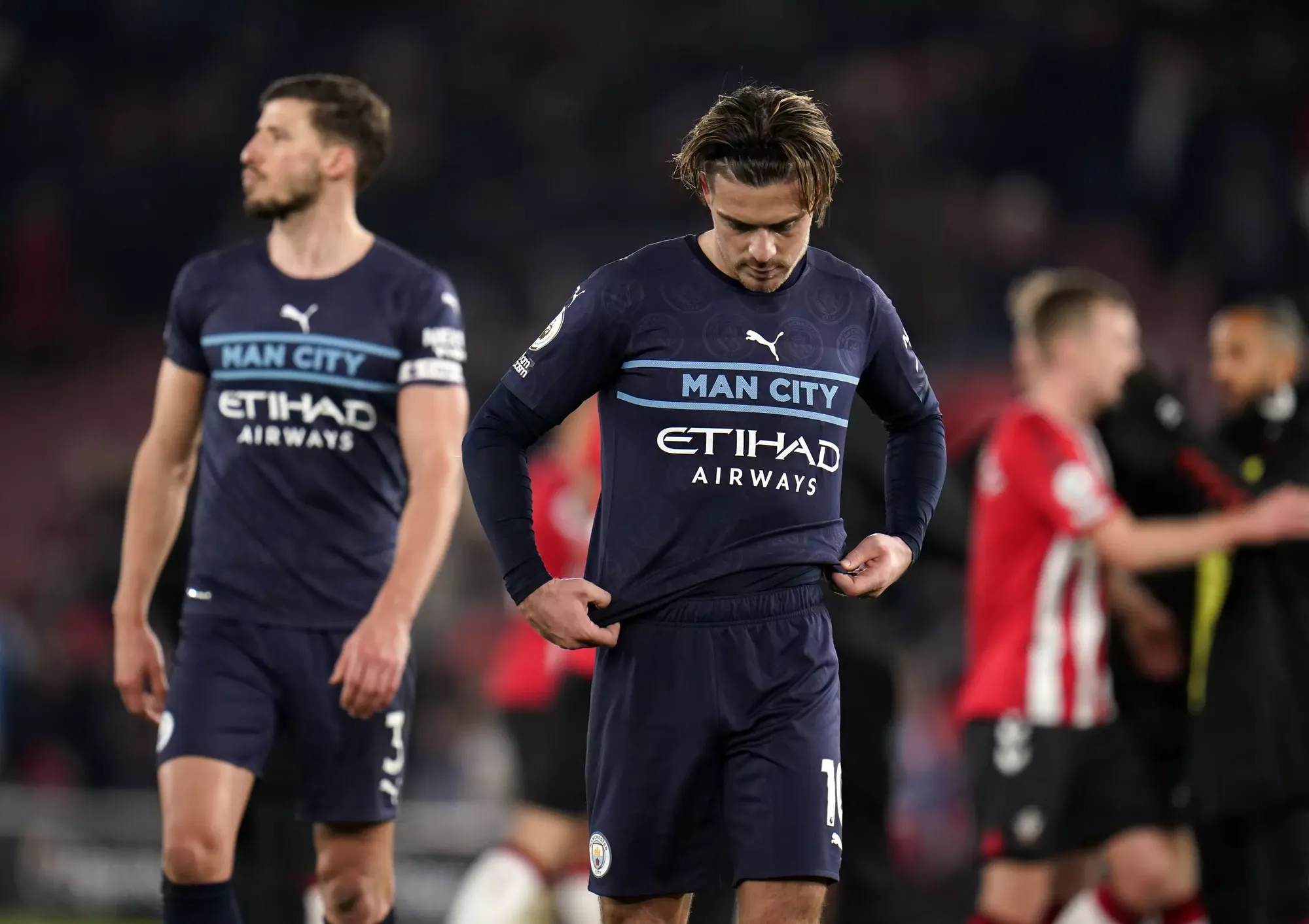 Manchester City players Jack Grealish and Aymeric Laporte cut frustrated figures